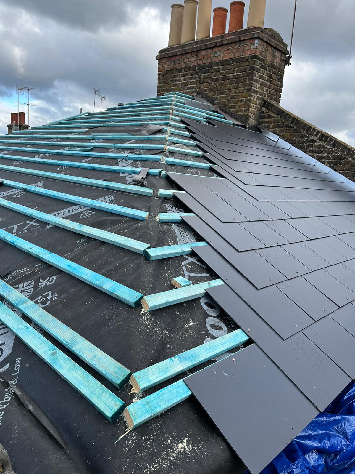 Professional roofers working on a property in London - KS Roof Master