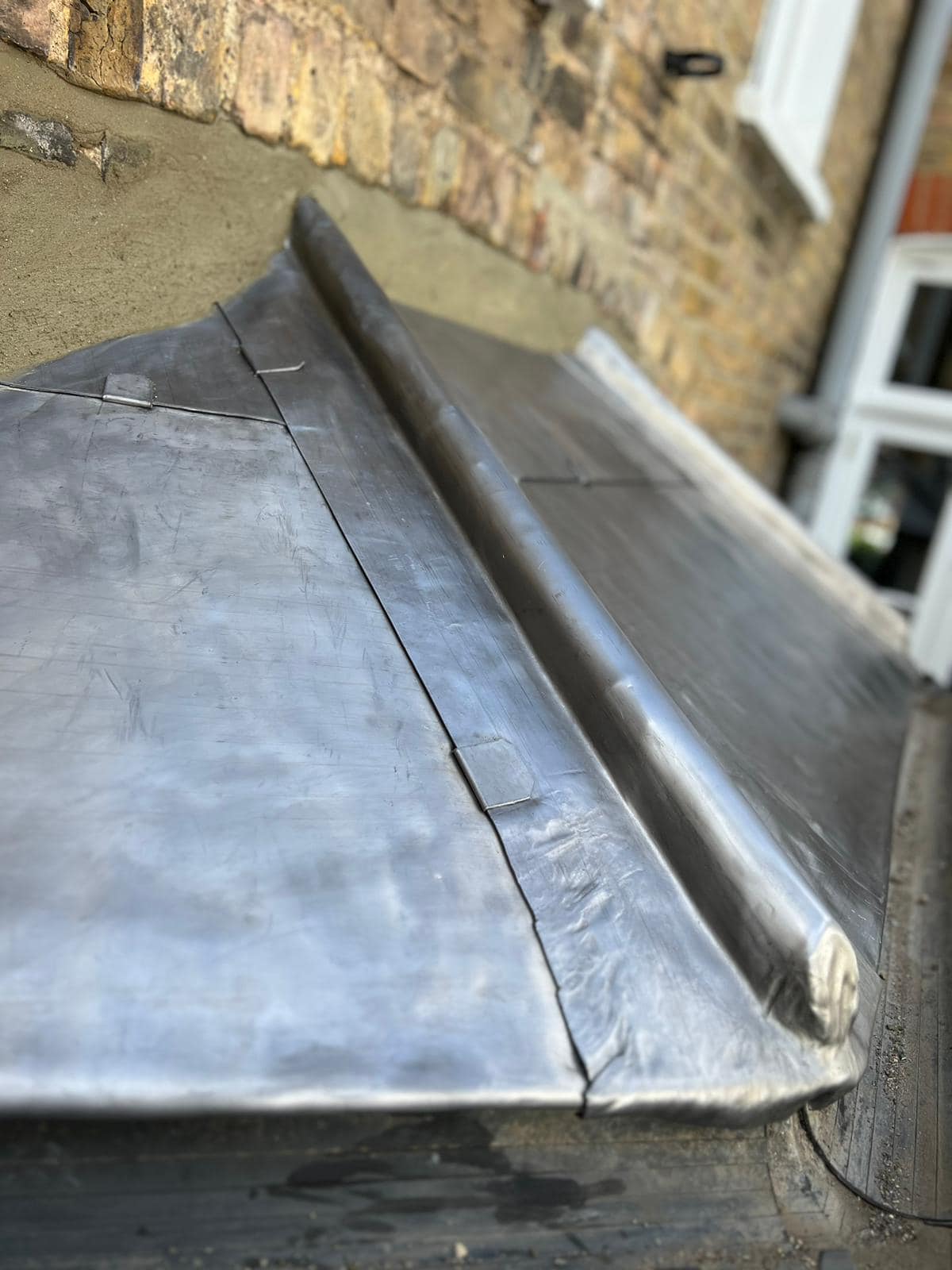 Professional roofers working on a property in London - KS Roof Master