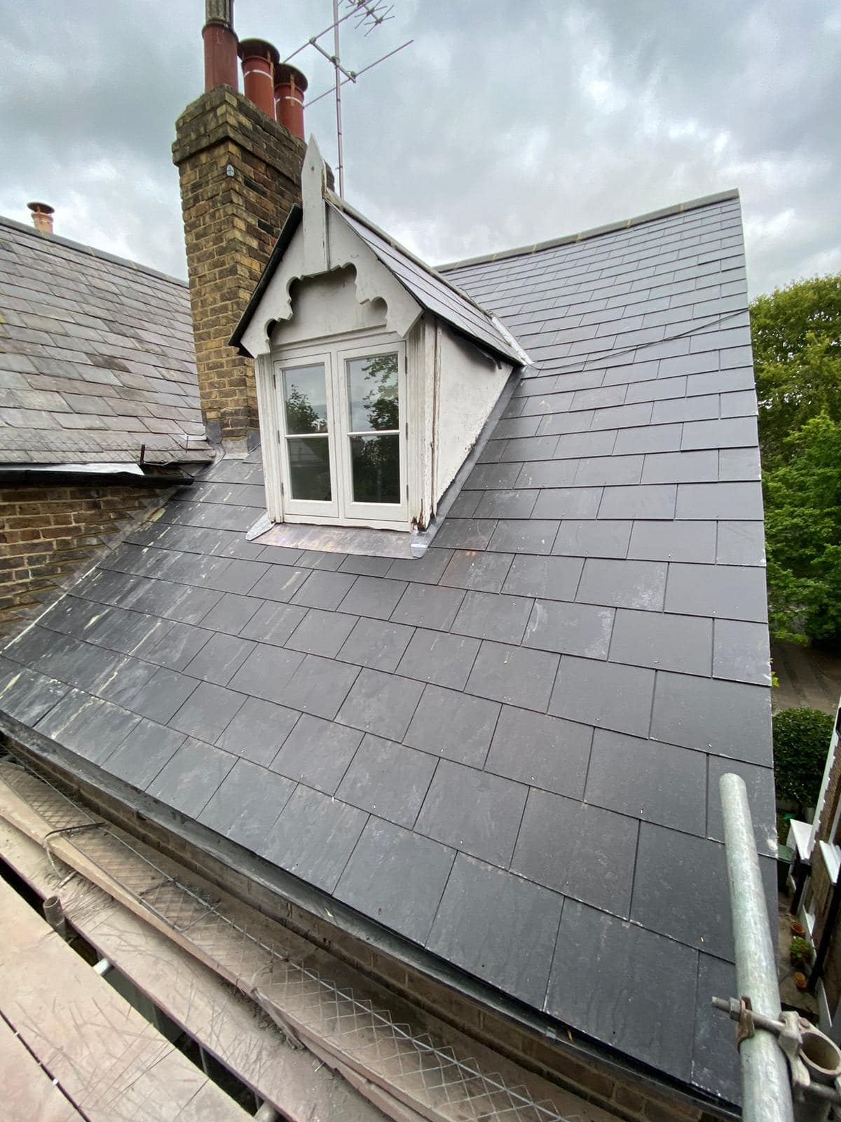 Professional roofers working on a property in London - KS Roof Master