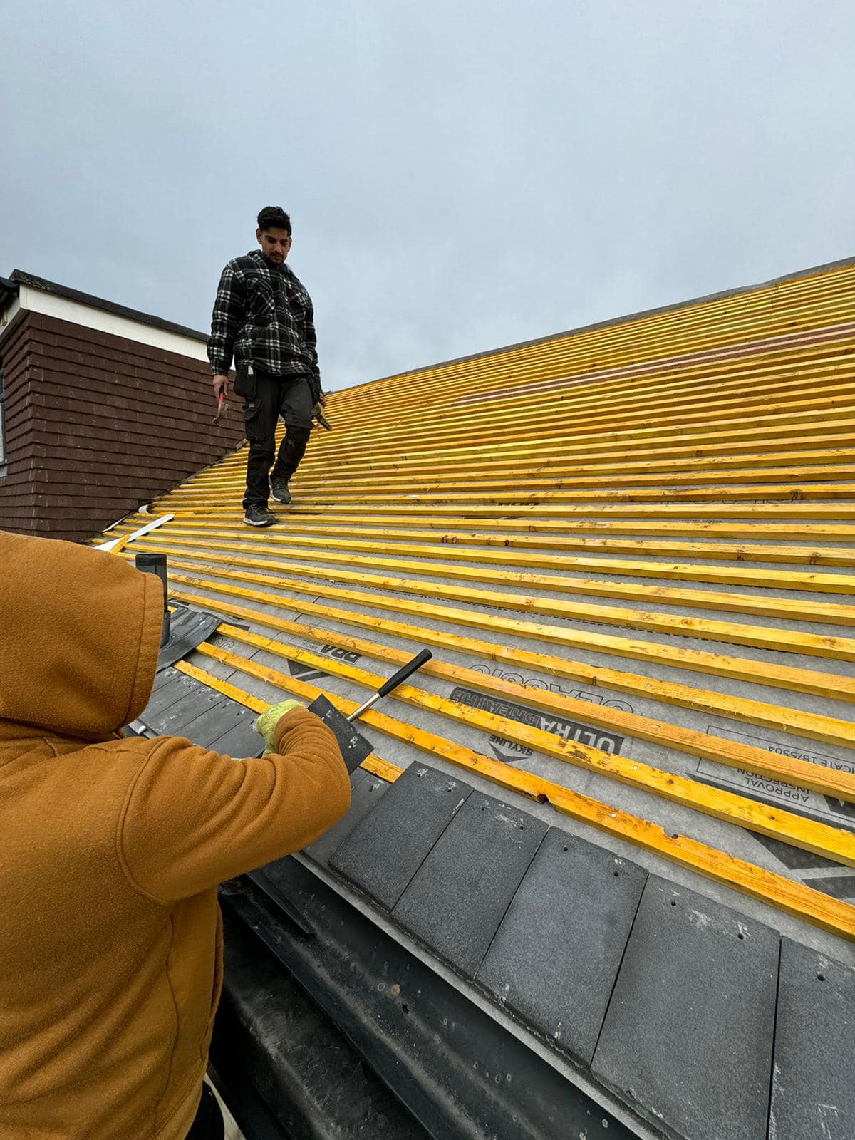 Professional roofers working on a property in London - KS Roof Master