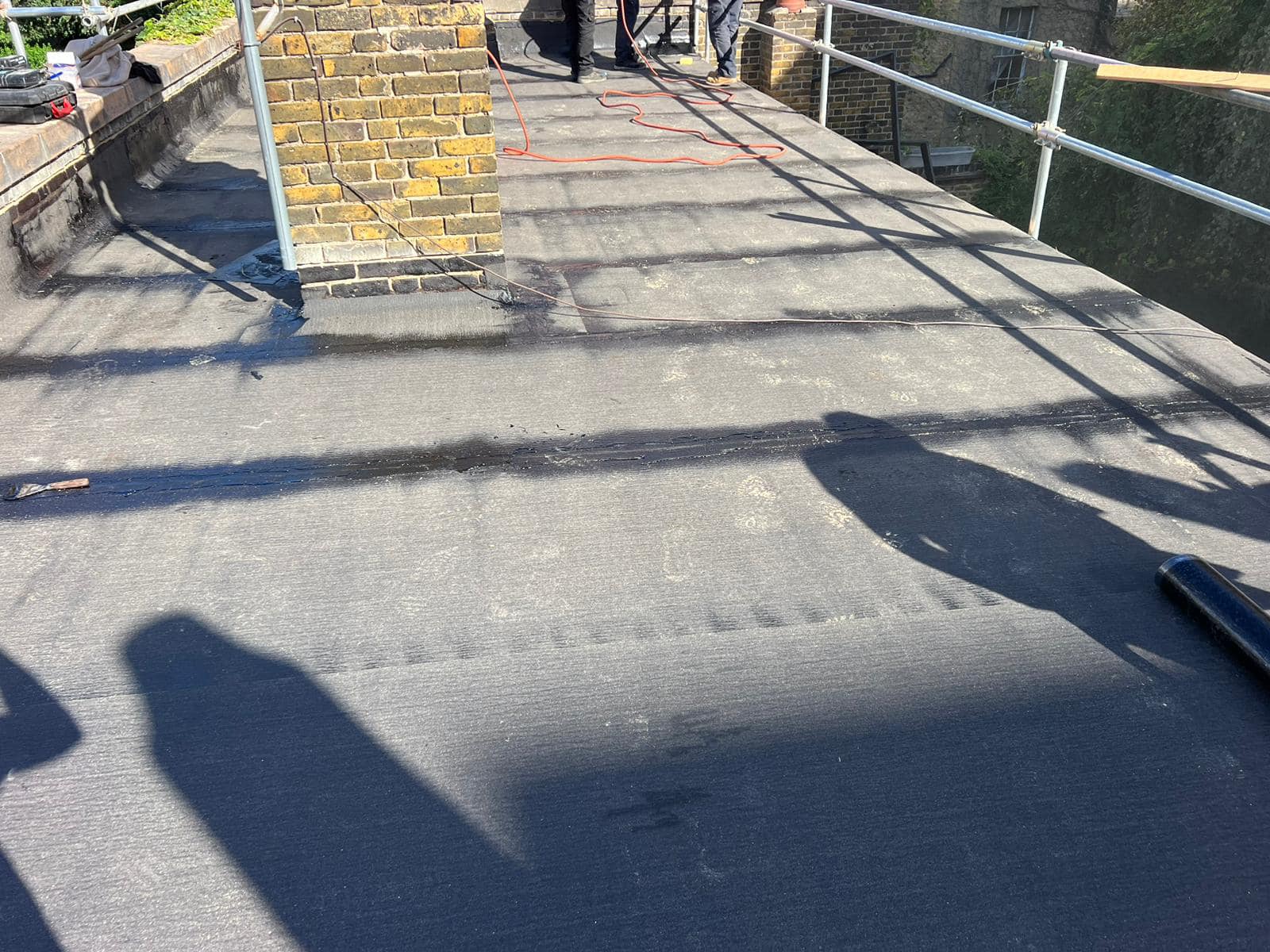 Professional roofers working on a property in London - KS Roof Master