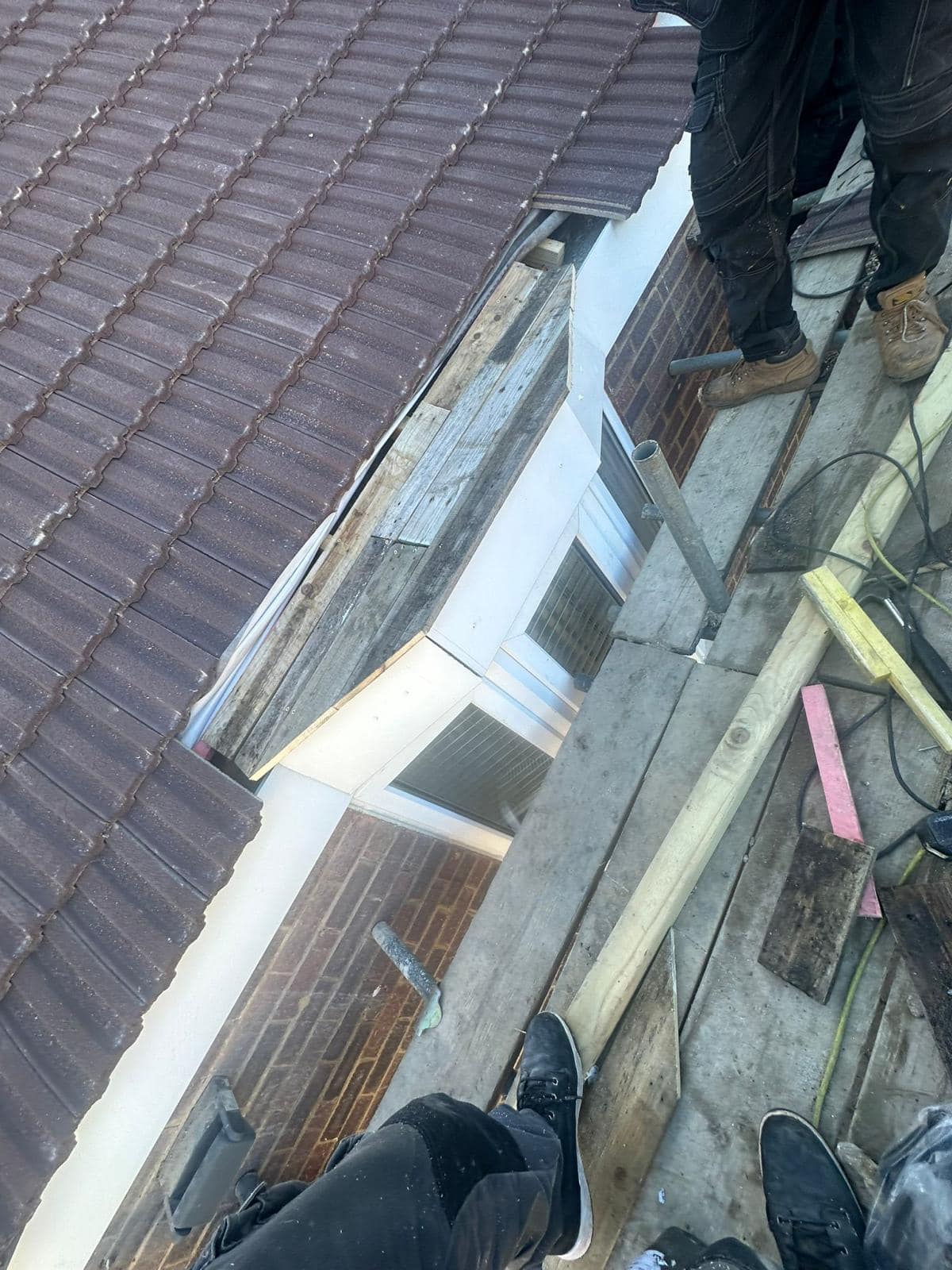 Professional roofers working on a property in London - KS Roof Master