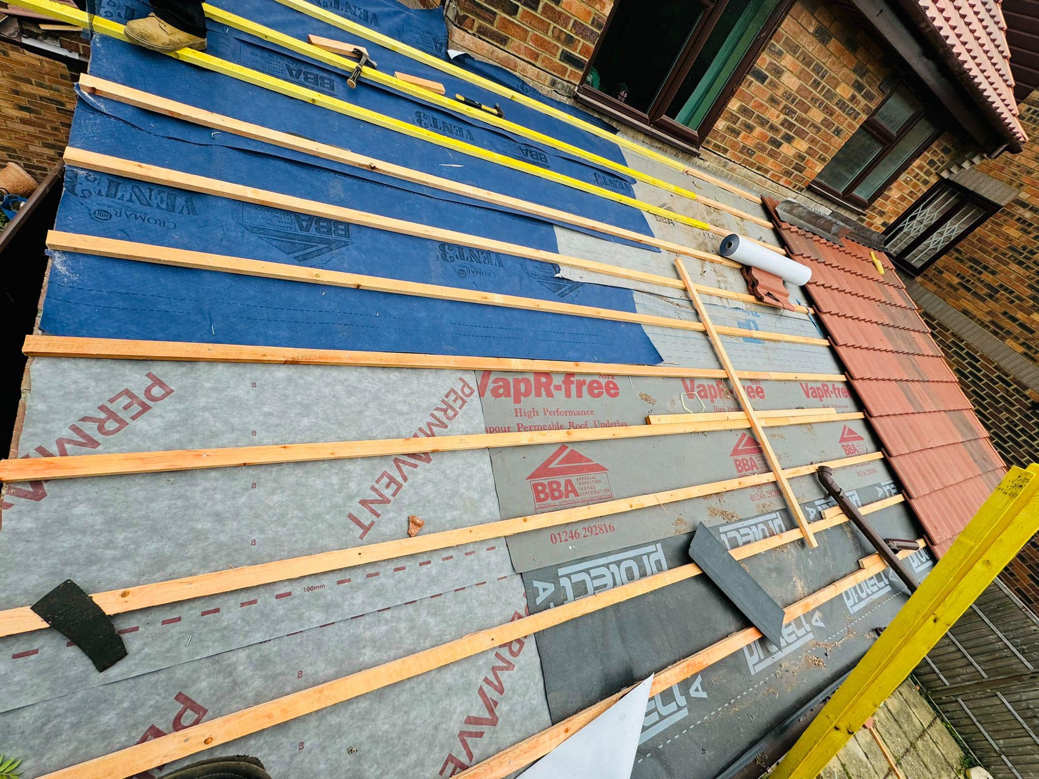 Professional roofers working on a property in London - KS Roof Master