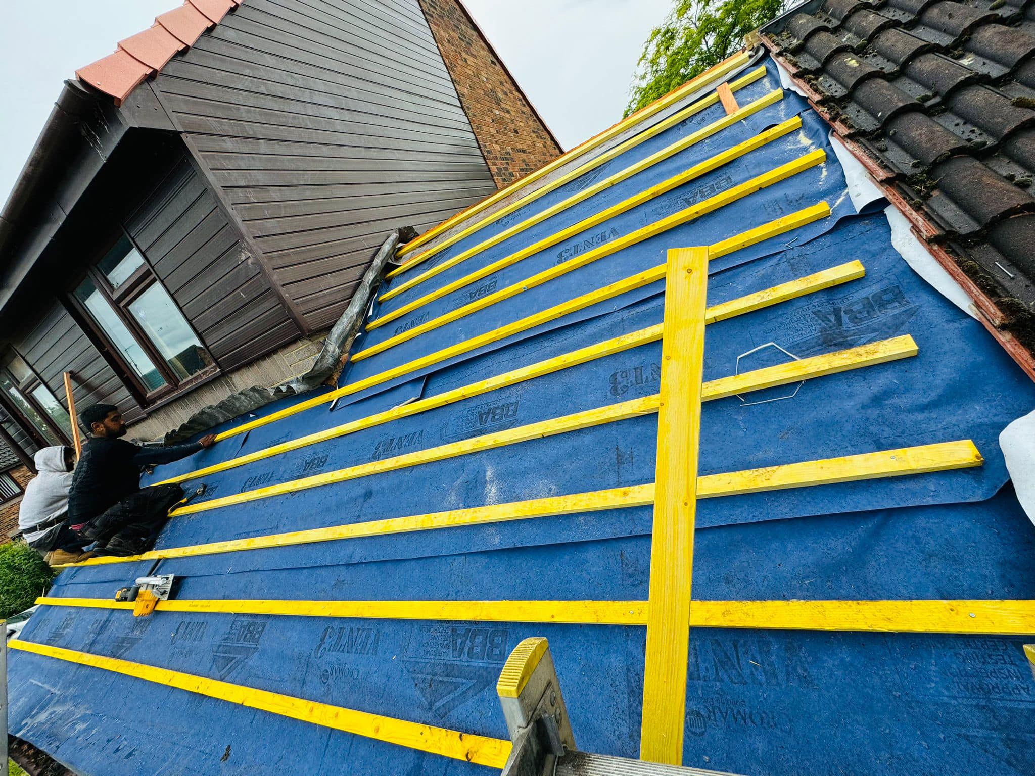 Professional roofers working on a property in London - KS Roof Master