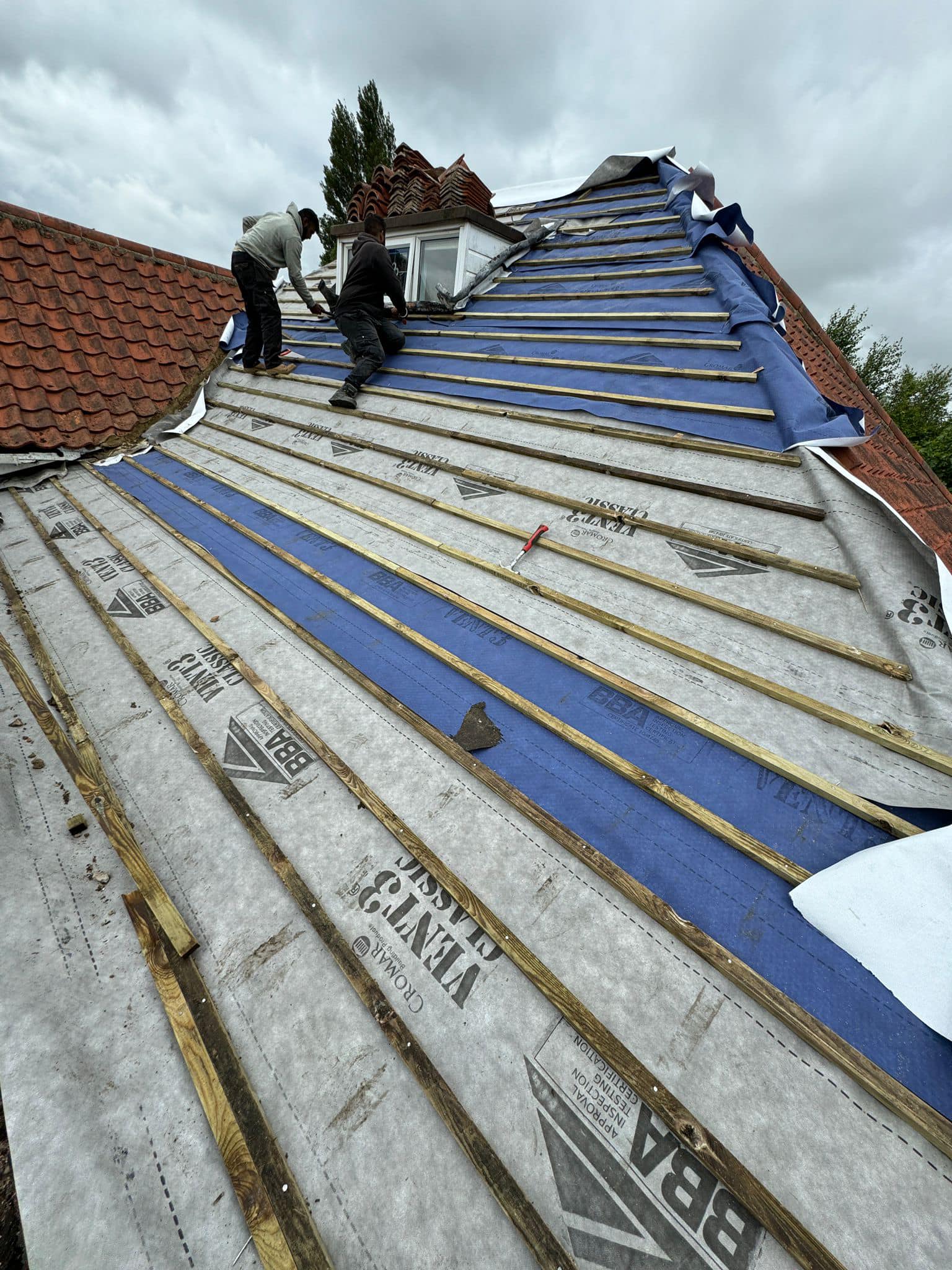 Professional roofers working on a property in London - KS Roof Master