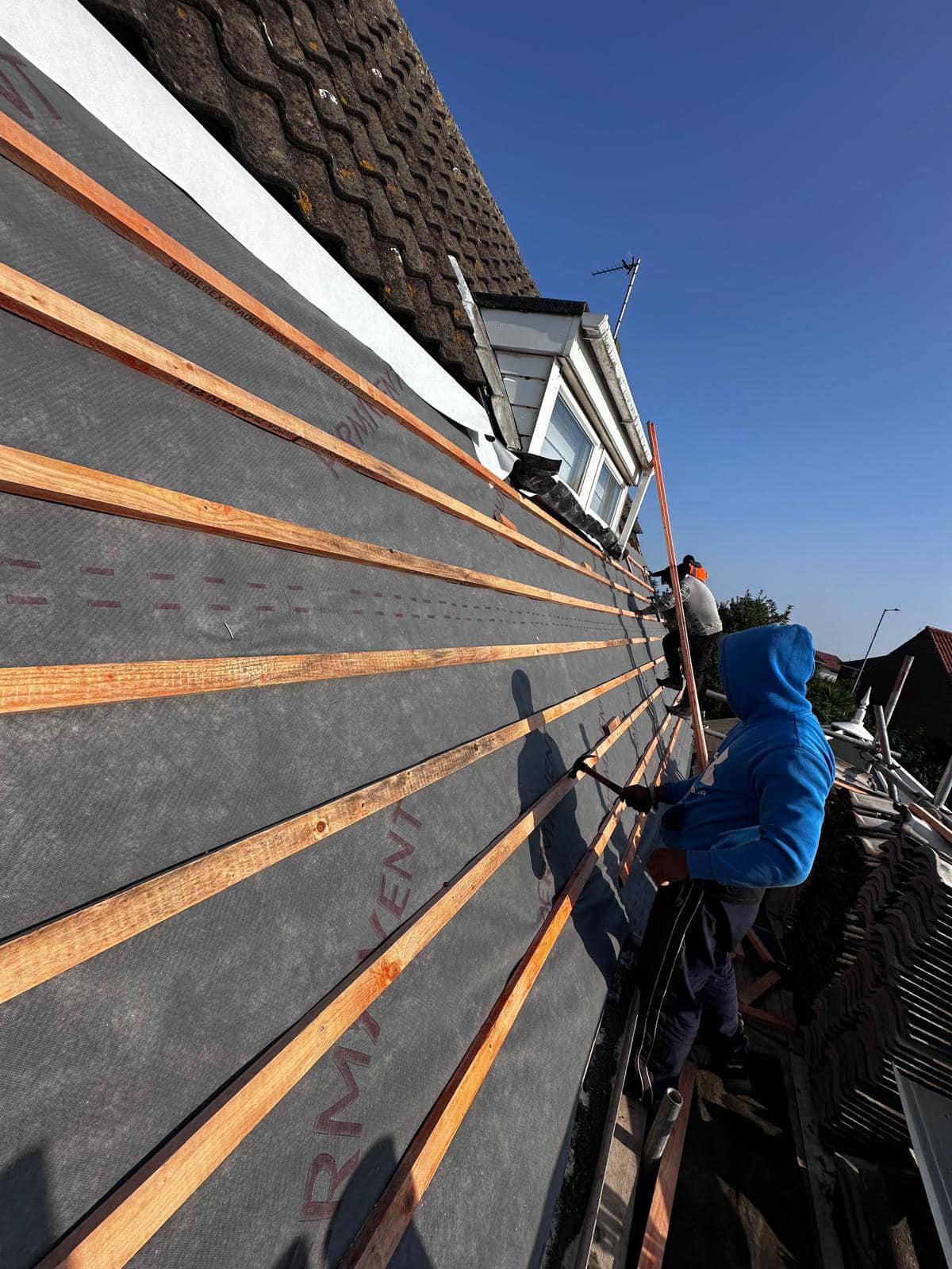 Professional roofers working on a property in London - KS Roof Master