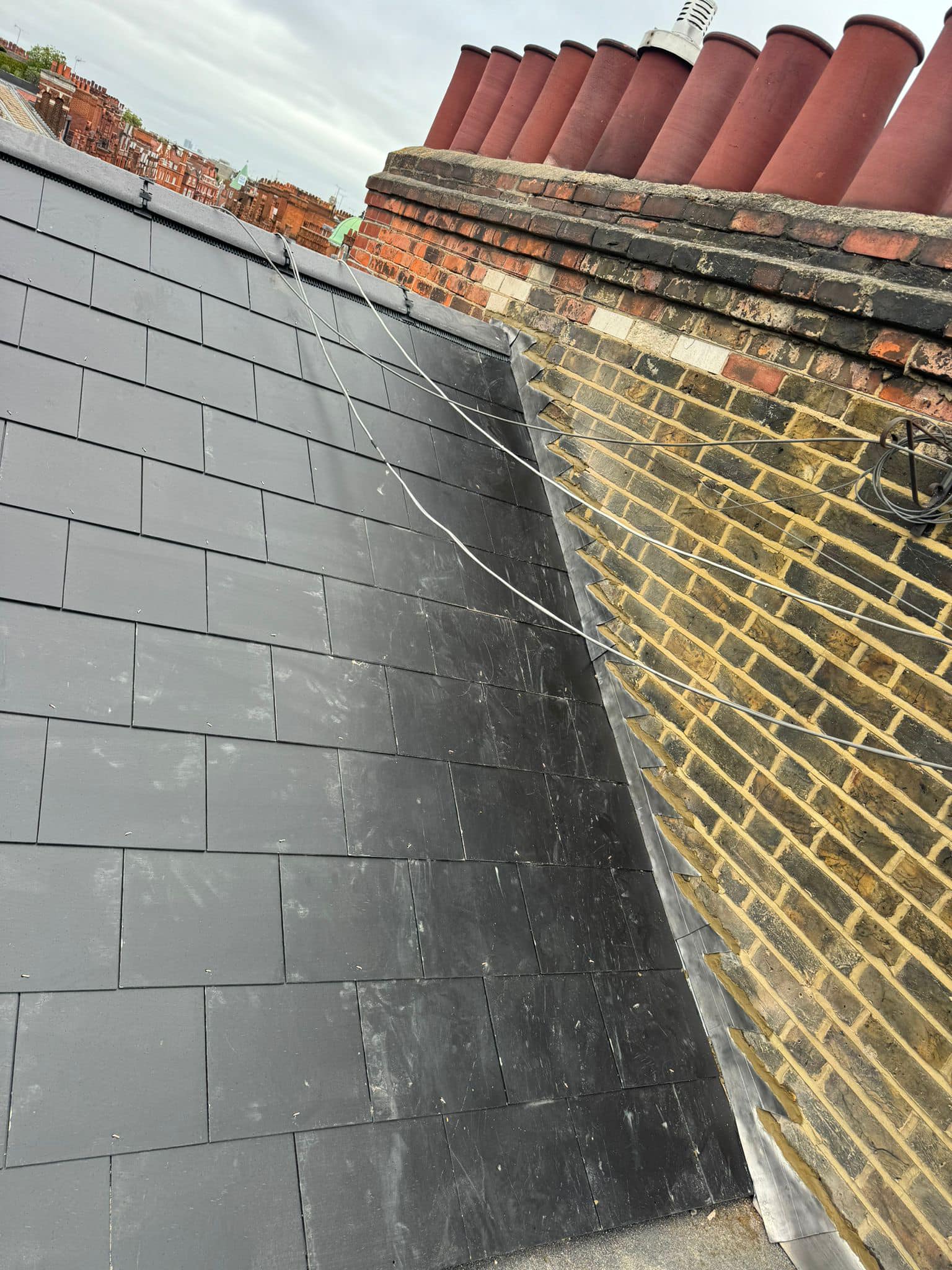 Professional roofers working on a property in London - KS Roof Master
