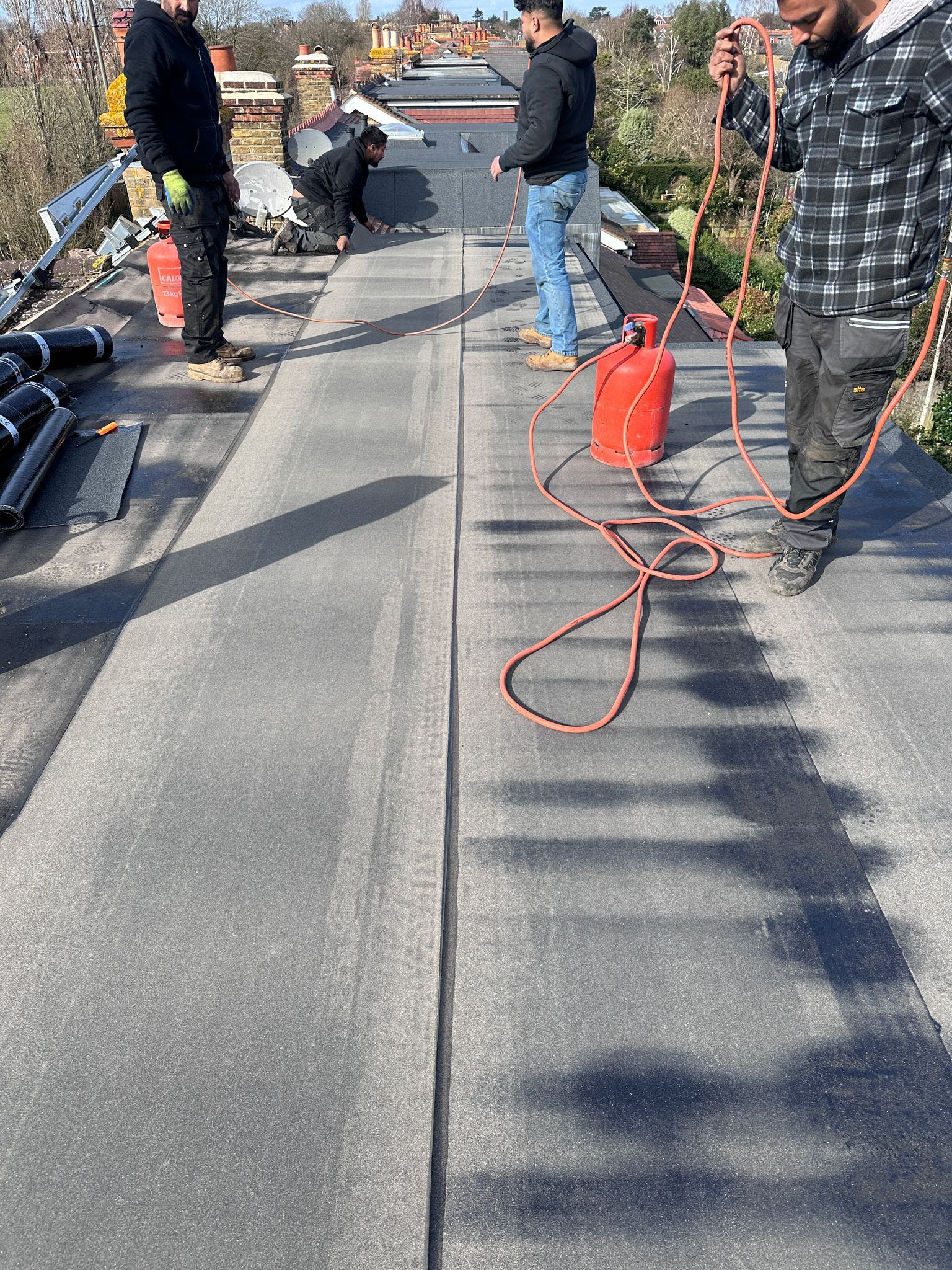 Professional roofers working on a property in London - KS Roof Master