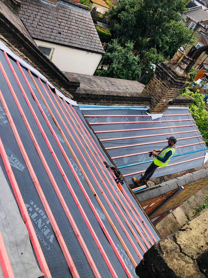 Professional roofers working on a property in London - KS Roof Master