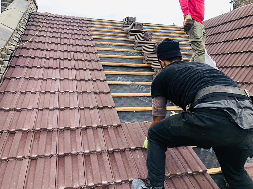 Professional roofers working on a property in London - KS Roof Master