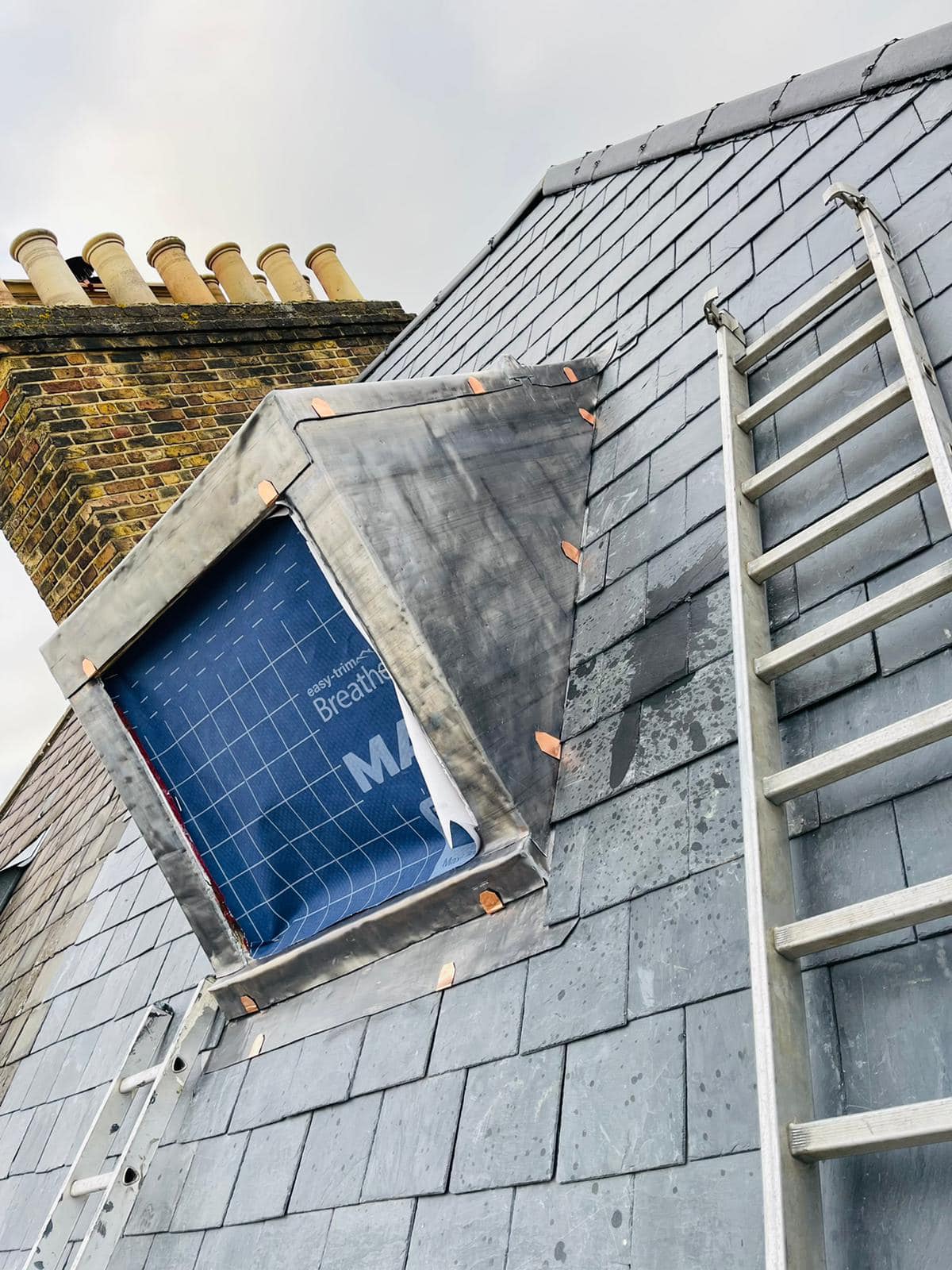 Professional roofers working on a property in London - KS Roof Master
