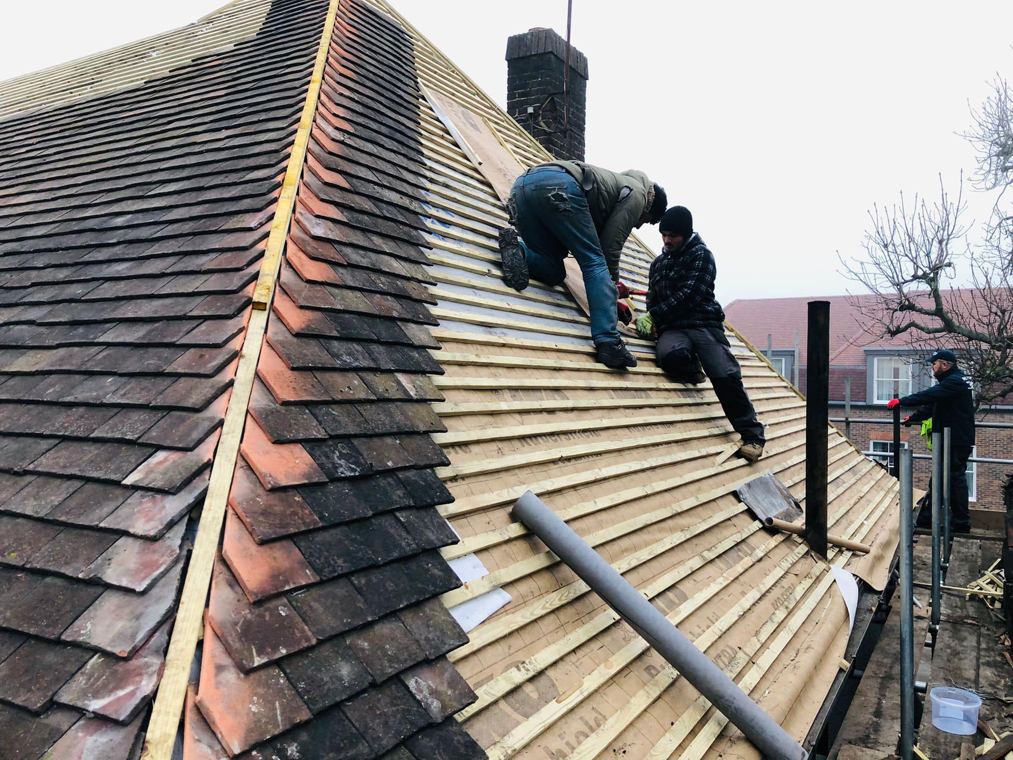Professional roofers working on a property in London - KS Roof Master