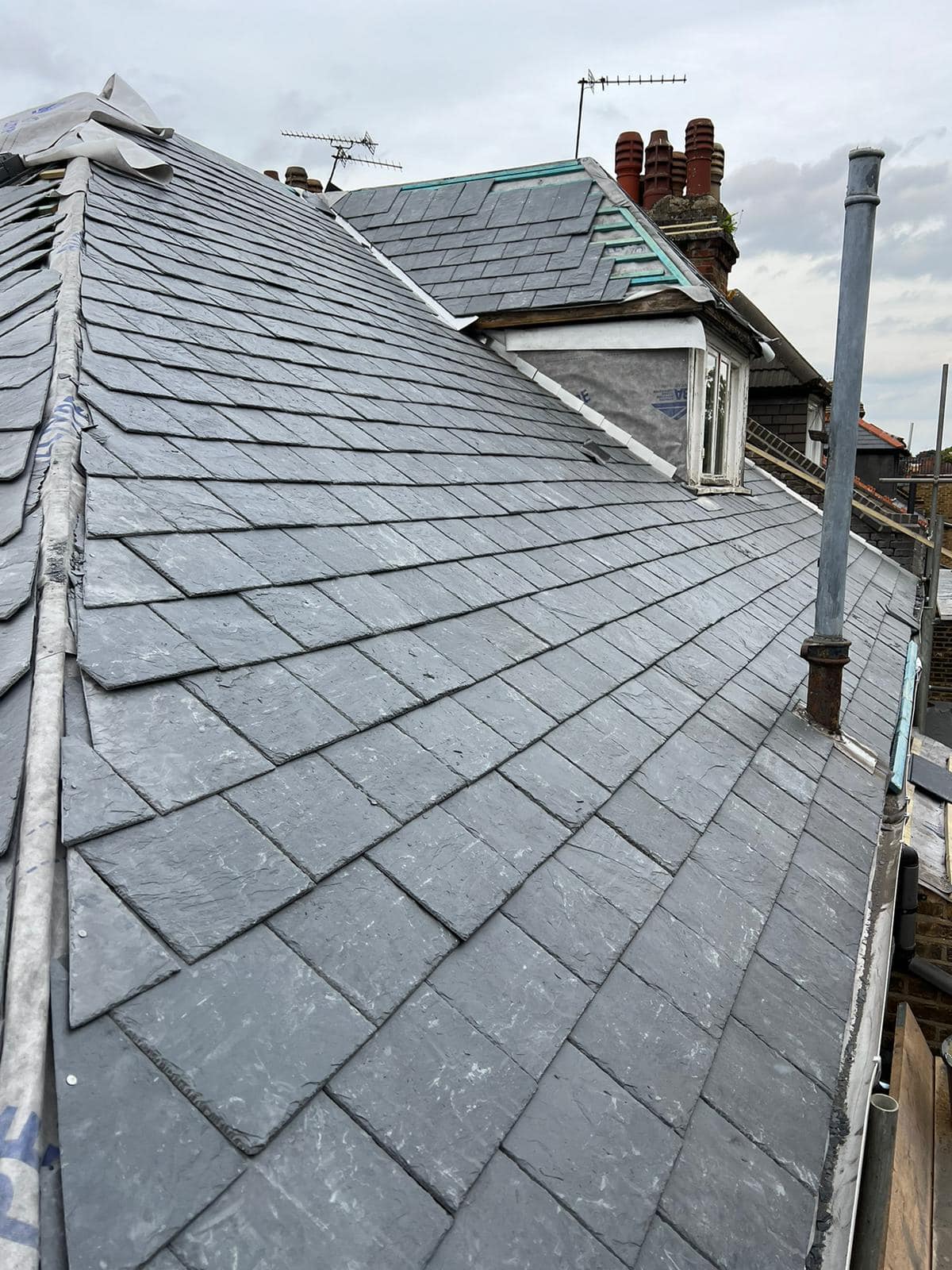 Professional roofers working on a property in London - KS Roof Master
